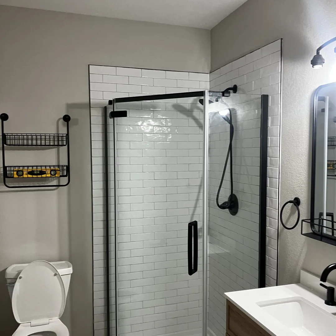 Tiled walk-in shower with white subway tile and matte black hardware by MrImproveIt